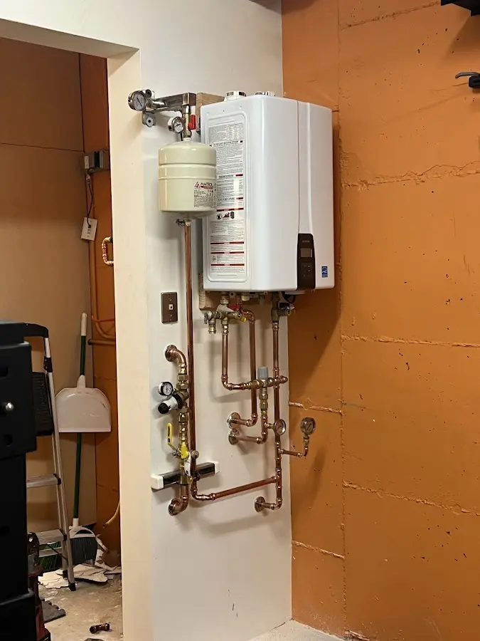 Plumbing technician inspecting water heater connections in Clearwater